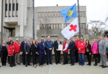 Suffolk Marks Red Cross Month with Flag Raising at Dennison Building